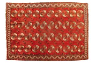 An antique/old "Country House"Turkmen carpet with madder red ground and a lattice of four rows of