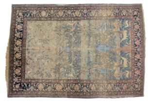 An "Old Country House" antique Ravar Kerman rug won a Persian blue ground, with a scene of an