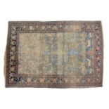 An "Old Country House" antique Ravar Kerman rug won a Persian blue ground, with a scene of an