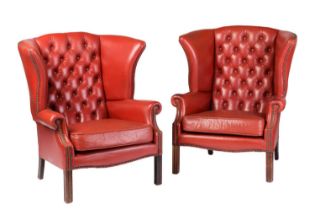 A pair of red leather button back wing armchairs, with moulded square section legs, late 20th