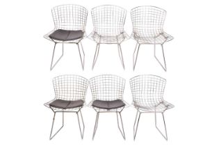 Harry Bertoia, a set of six dining chairs, three with leatherette seats, 76 cm high x 54 cm wide.