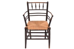 A Sussex-type spindle-backed armchair, 19th century, the ebonized ash frame with woven rush seat, 56