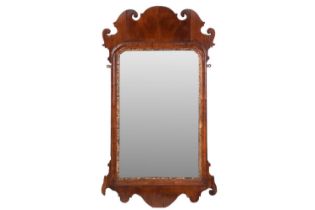 A George IV flame-grained mahogany scroll frame wall mirror, with gilt slip and cross grain