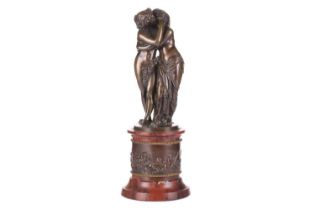 19th century French school, a patinated bronze figure group of Cupid and Psyche embracing, raised on