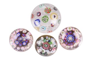 A nineteenth-century Baccarat paperweight, millefiori canes spaced on white muslin with the date