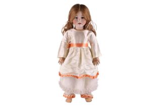 A late 19th-century French Bebe Jumeau French doll, with jointed limbs and wearing a white silk
