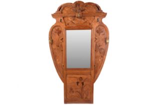 A French oak and marquetry hall mirror with distinctive iris motifs in the manner of Emile Galle,