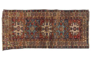 An antique Caucasian Lesghi rug with five geometric stars on a panelled ground with multiple