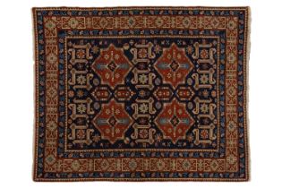 An Azerbaijan rug of indigo blue ground, with four star-shaped tiles within a kufic border, 136 cm x