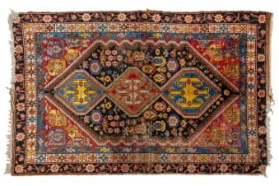 An old blue/black ground Qashqai rug with bright geometric lozenges within multiple borders, 244