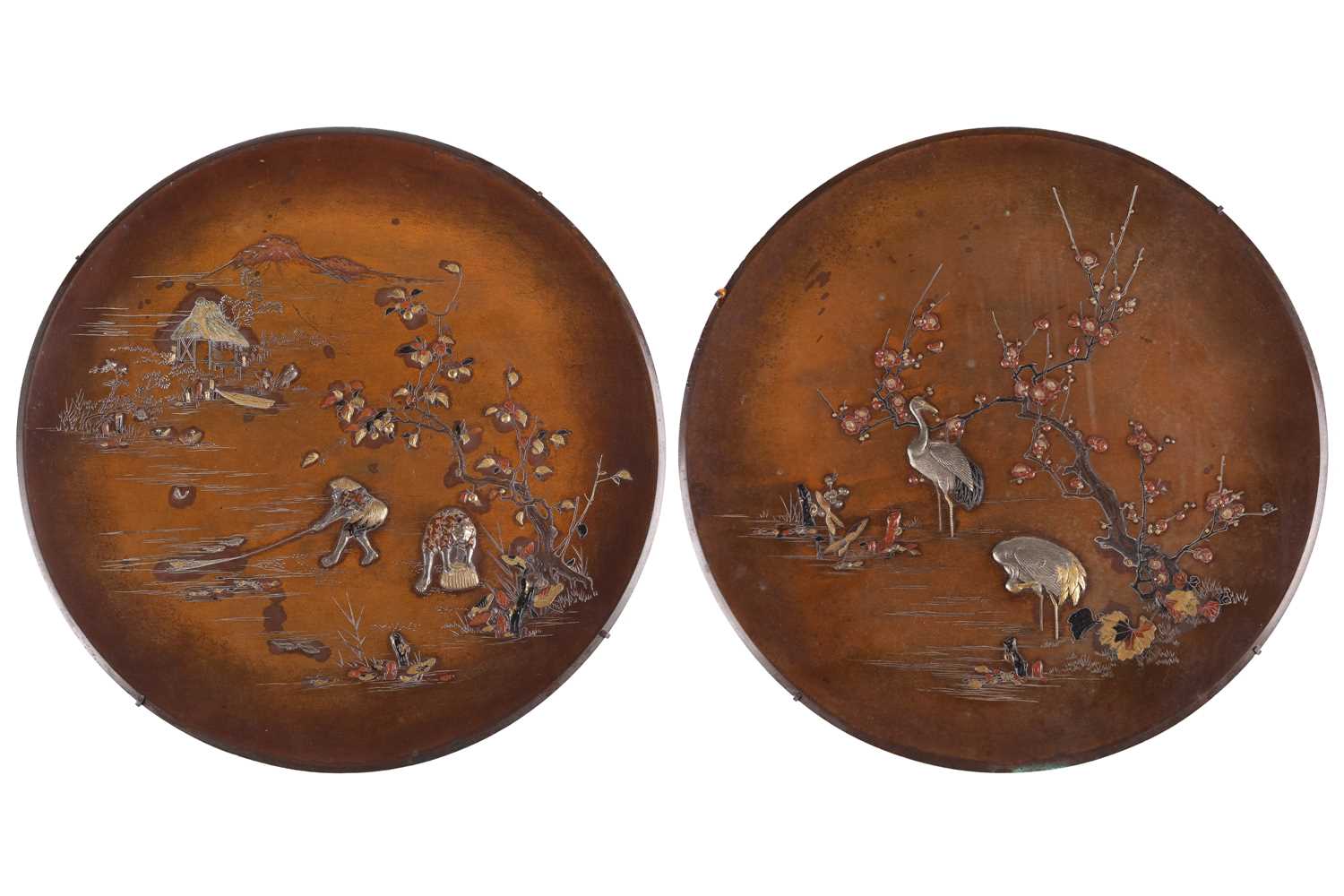 A matched pair of Japanese bronze circular chargers, Meiji Period, late 19th century, decorated with