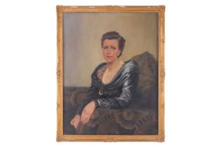 Early 20th-century British school, a half-length portrait of a lady in a blue dress, oil on