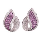 A pair of diamond and pink sapphire earrings, each earring in an organic foliate design pave set