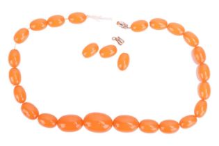 A simulated amber bead necklace, the beads graduating in size with the largest bead measuring 22.3 x