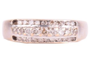 A three-row diamond dress ring, centred with a line of pavé-set diamonds edged by two rows of