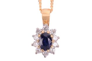 A sapphire and diamond cluster pendant in 18ct bi-colour gold, featuring a centred mixed cut oval