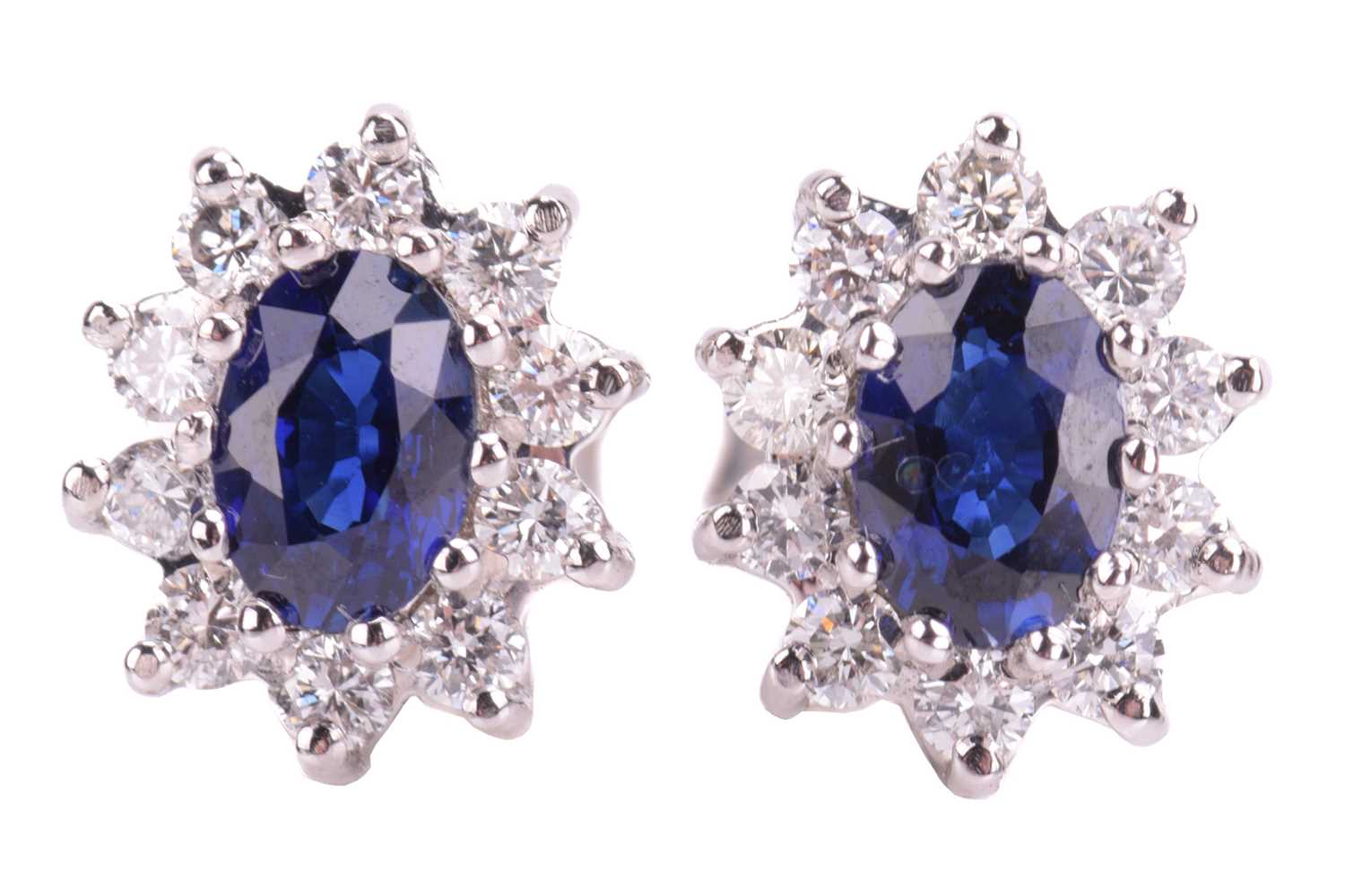 A pair of sapphire and diamond cluster earrings in 18ct white gold, each comprising an oval-cut