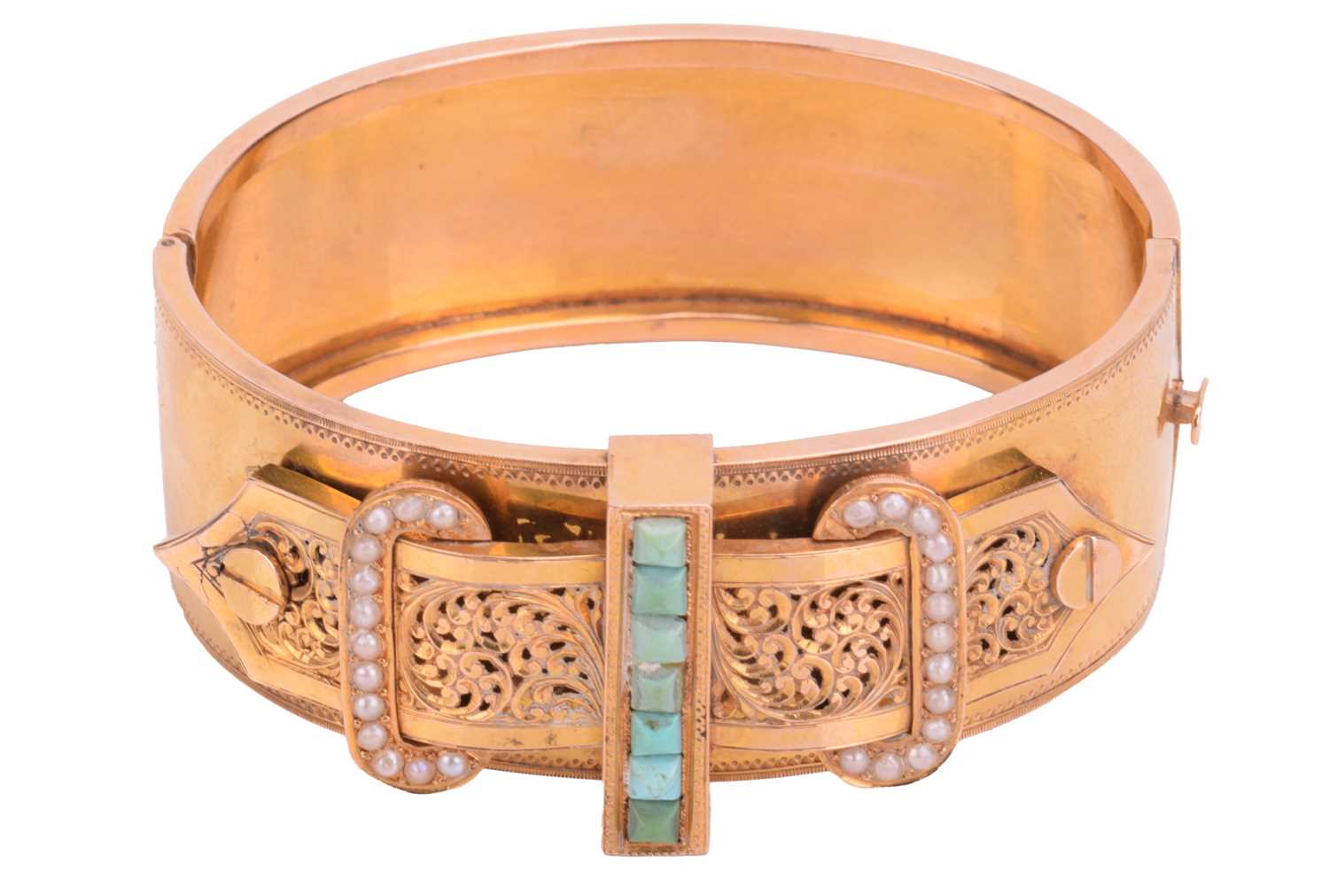 A Victorian buckle bangle in yellow metal featuring a turquoise and seed pearl set buckle with a - Image 2 of 5