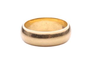 A wedding ring in 18ct gold, the D-section band measuring 6.4mm in width, with hallmarks for 18ct