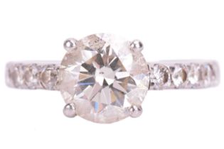 A single stone diamond ring; the round brilliant cut diamond in four claw mount above dimond set