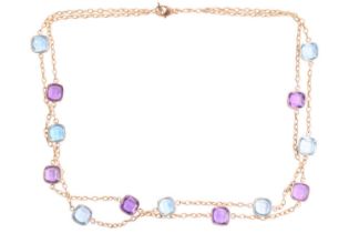 An amethyst and blue topaz double strand necklace featuring six bezel set amethysts and seven