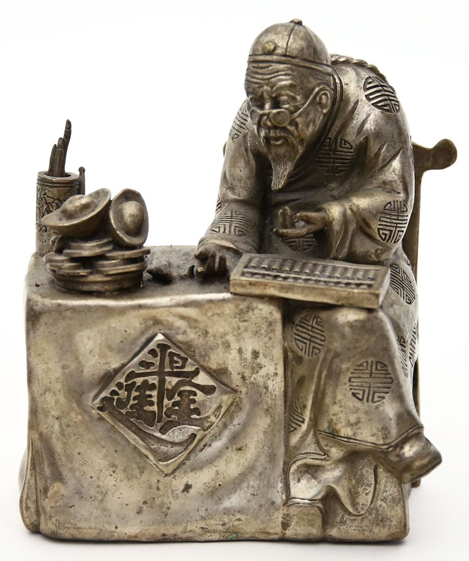 Skulptur "Geld zählender Kaufmann".