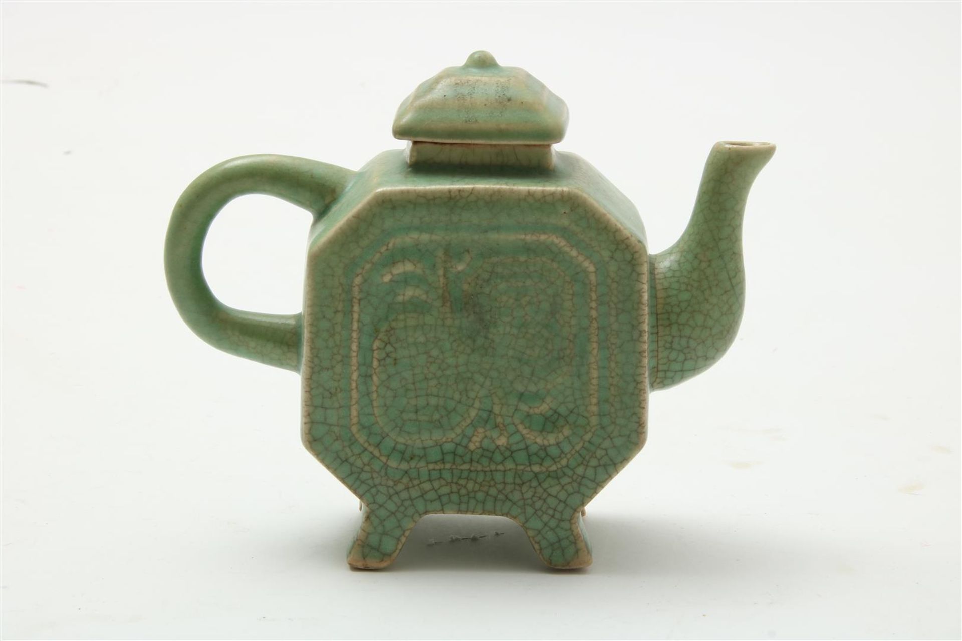 Porcelain teapot with celadon glaze and relief decor, 19th/20th century, h. 15 cm.