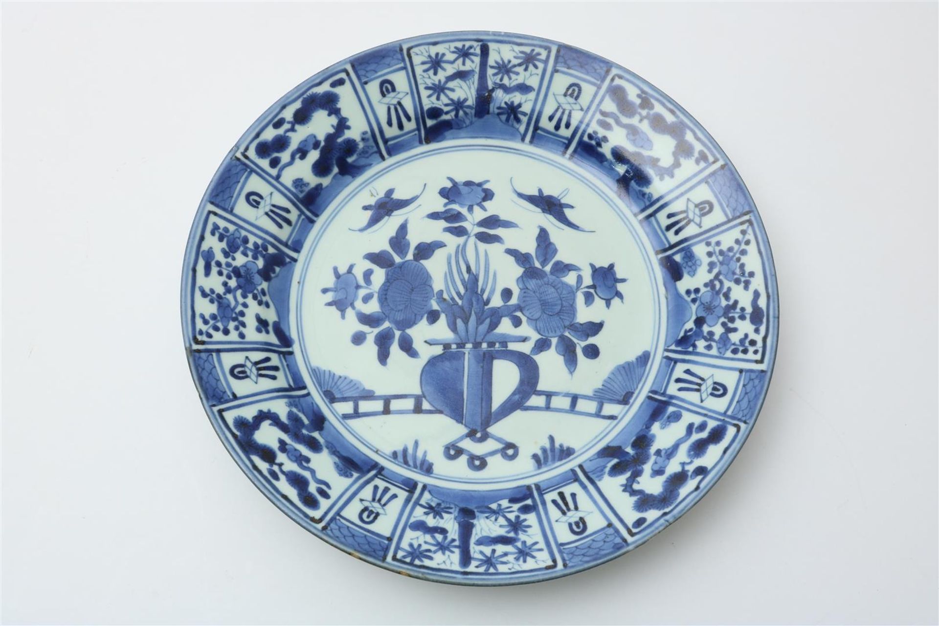 Porcelain Arita dish with central decoration of flowers in vase and cartouche edge decoration,