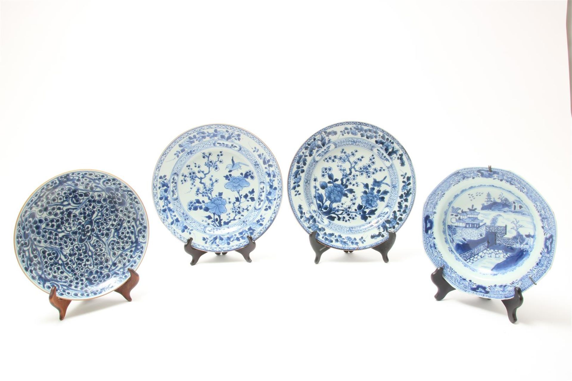 Set of porcelain Qianlong plates with a bird near flowering shrubs and a blossom branch,