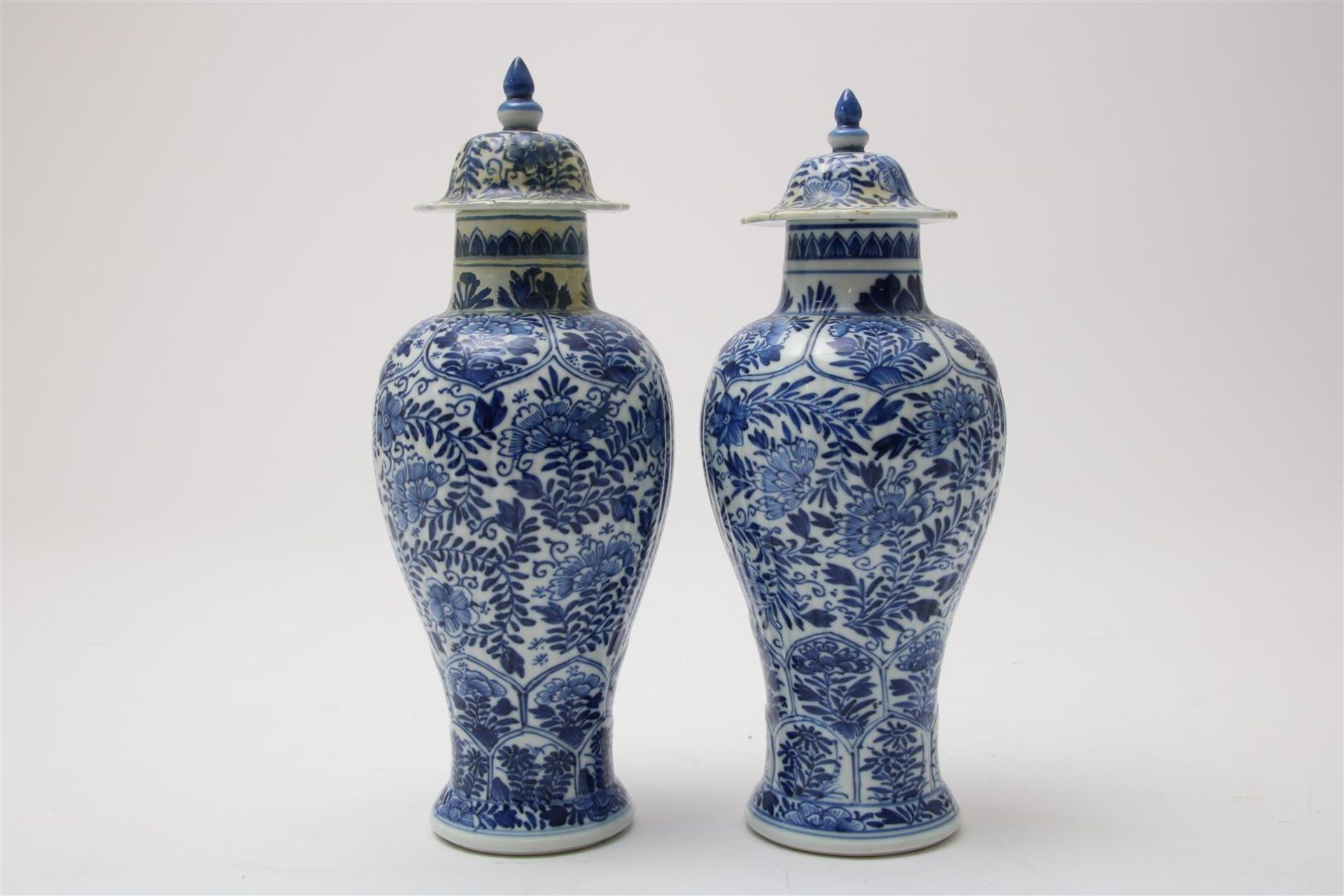 Set of porcelain baluster-shaped lidded vases with cartouches and flowering shrubs decoration, China