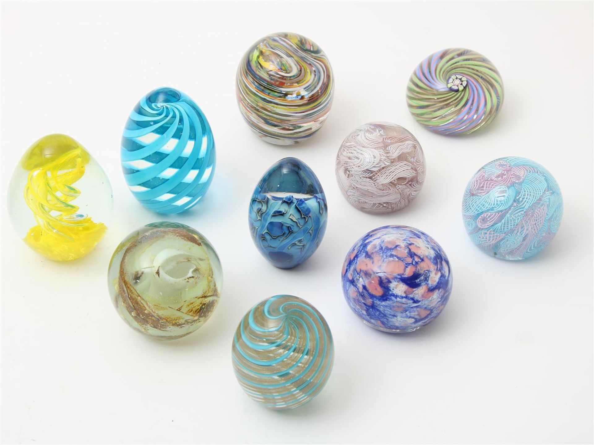 Series of 10 thick glass ball and egg shaped paperweights, with redeemed spiral decor, possibly