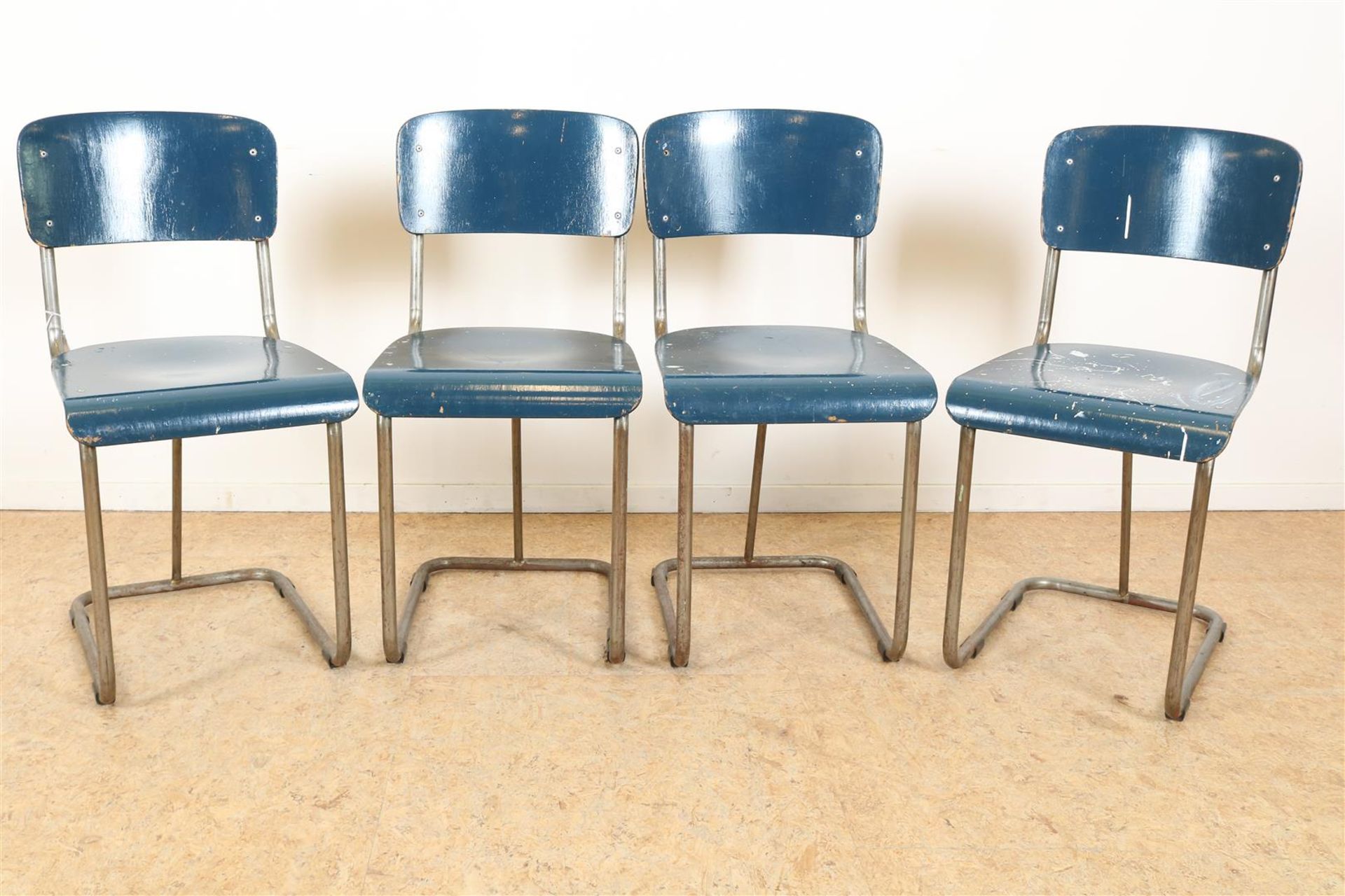 Series of 4 chrome tube Gispen chairs with blue wooden seat and backrest, model 107, produced