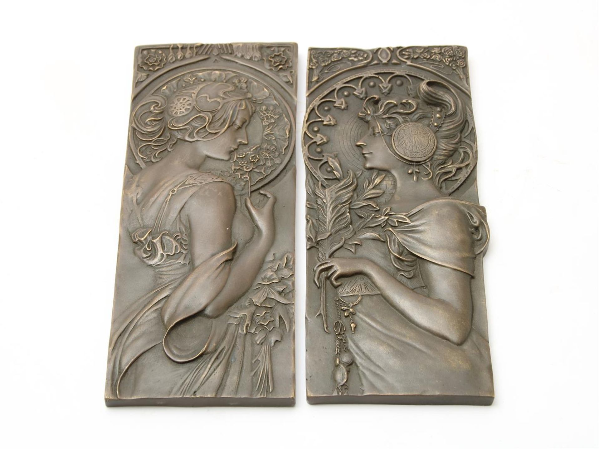Set of bronze Art Nouveau-style plaques with relief decor of female figures, after Mucha, 23 x 9