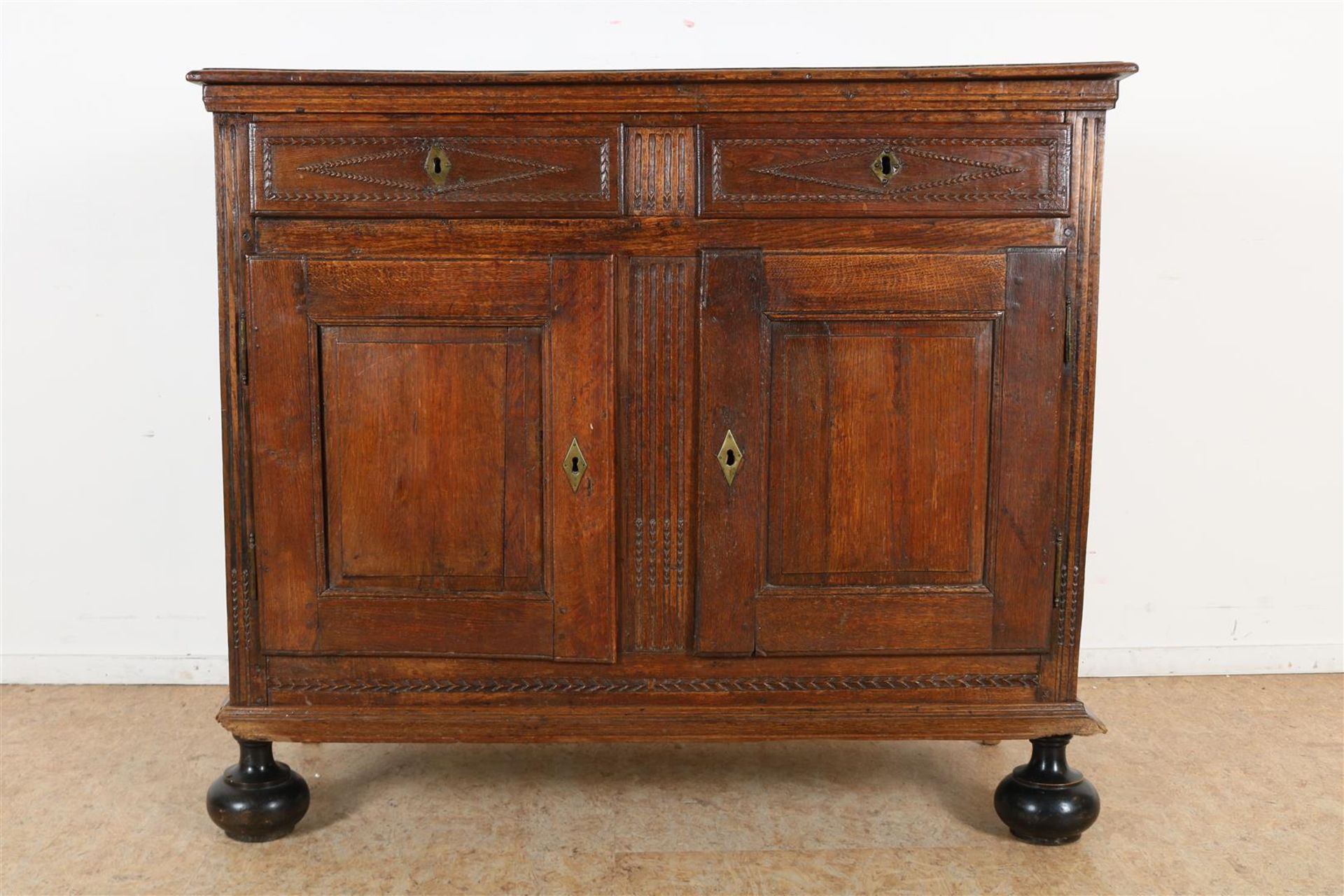 Oak sideboard with 2 inserted drawers and 2 panel doors on ball feet, 18th century, h. 112, w.