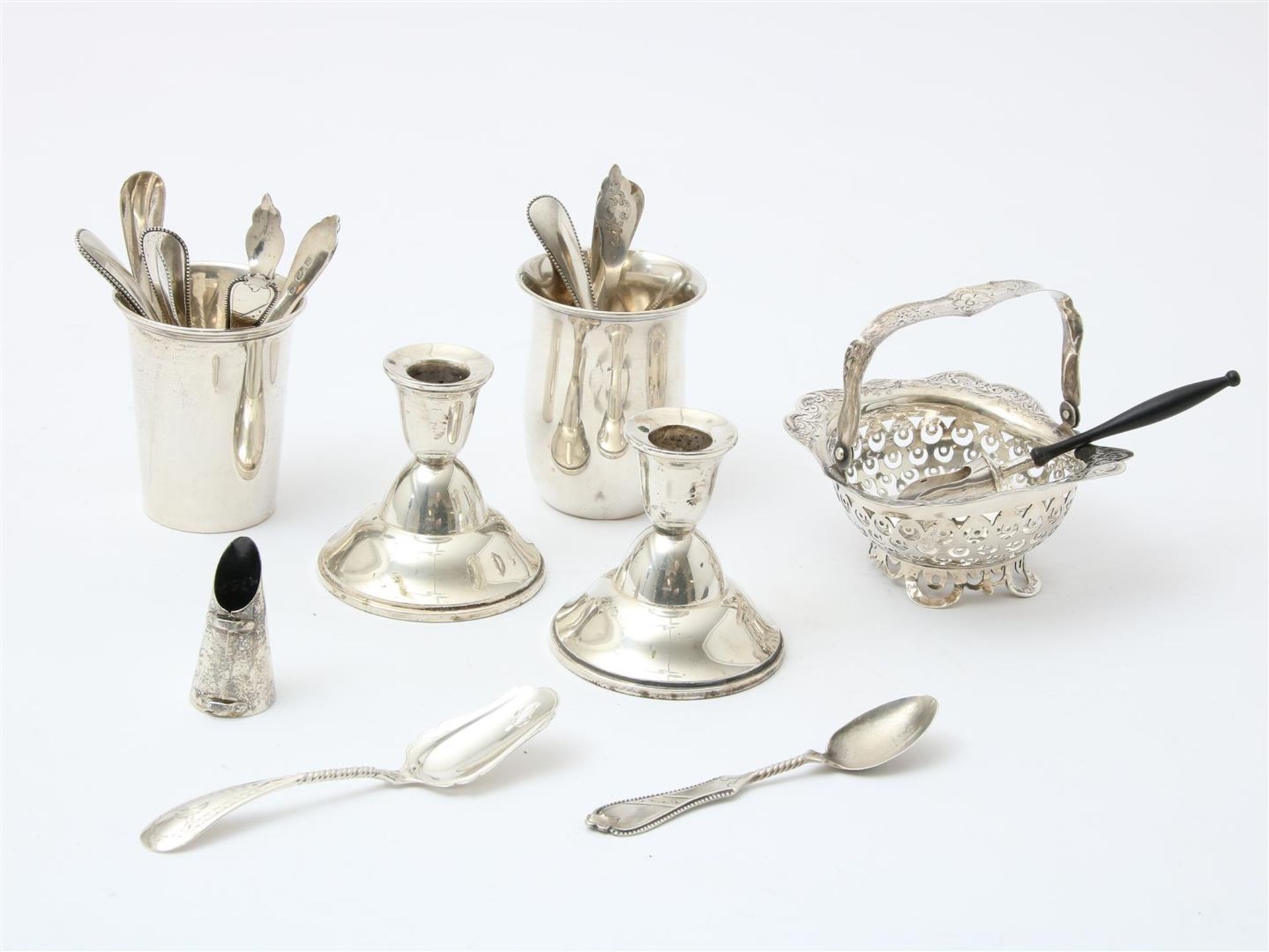 Lot of silverware including 2 cups, 2 single-light candlesticks, teaspoons, candy tray (size