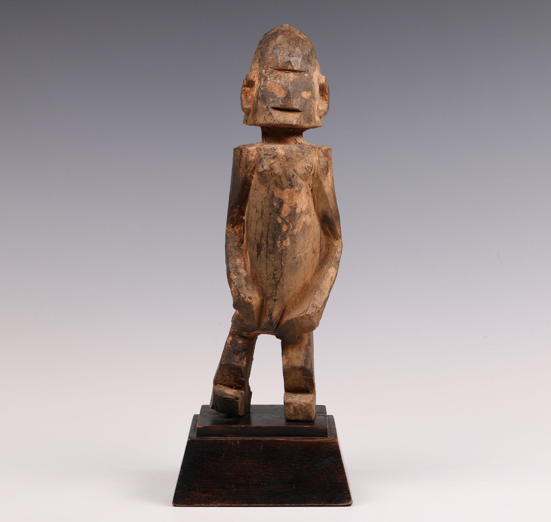 Dogon, robust cubic wooden standing figure.