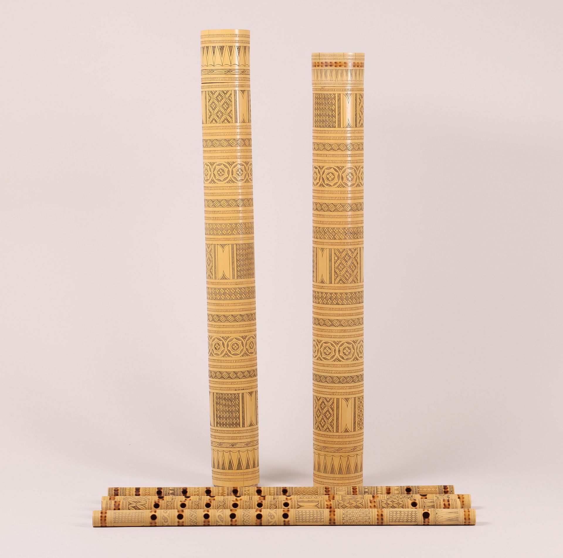 Sulawesi, Toraja, two large bamboo containers and four bamboo flutes, suling;