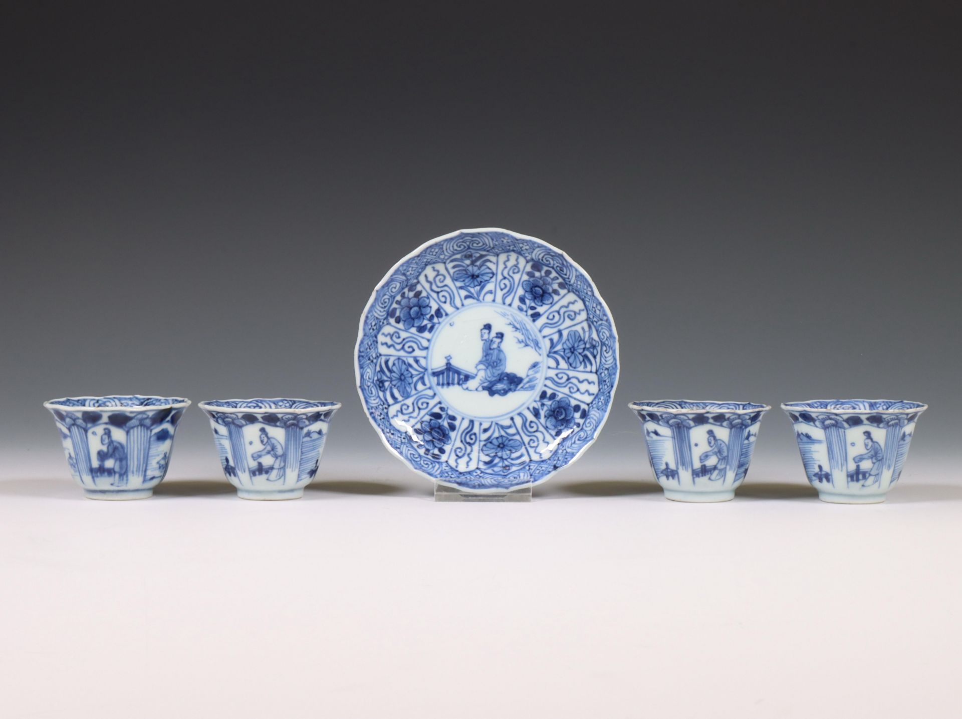 China, set of four blue and white porcelain cups and one saucer, 18th century,