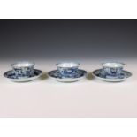 China, set of three blue and white porcelain cups and saucers, 18th century,