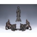 China, pair of bronze Buddhist lions and a model of a monk, 20th century,