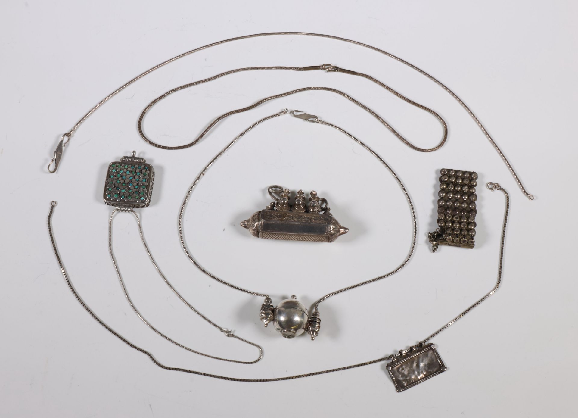India, three silver alloy amulet holders, a bracelet and a necklace with amulet