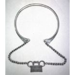 Golden Triangle, a silver alloy neckring with chain and pendant,