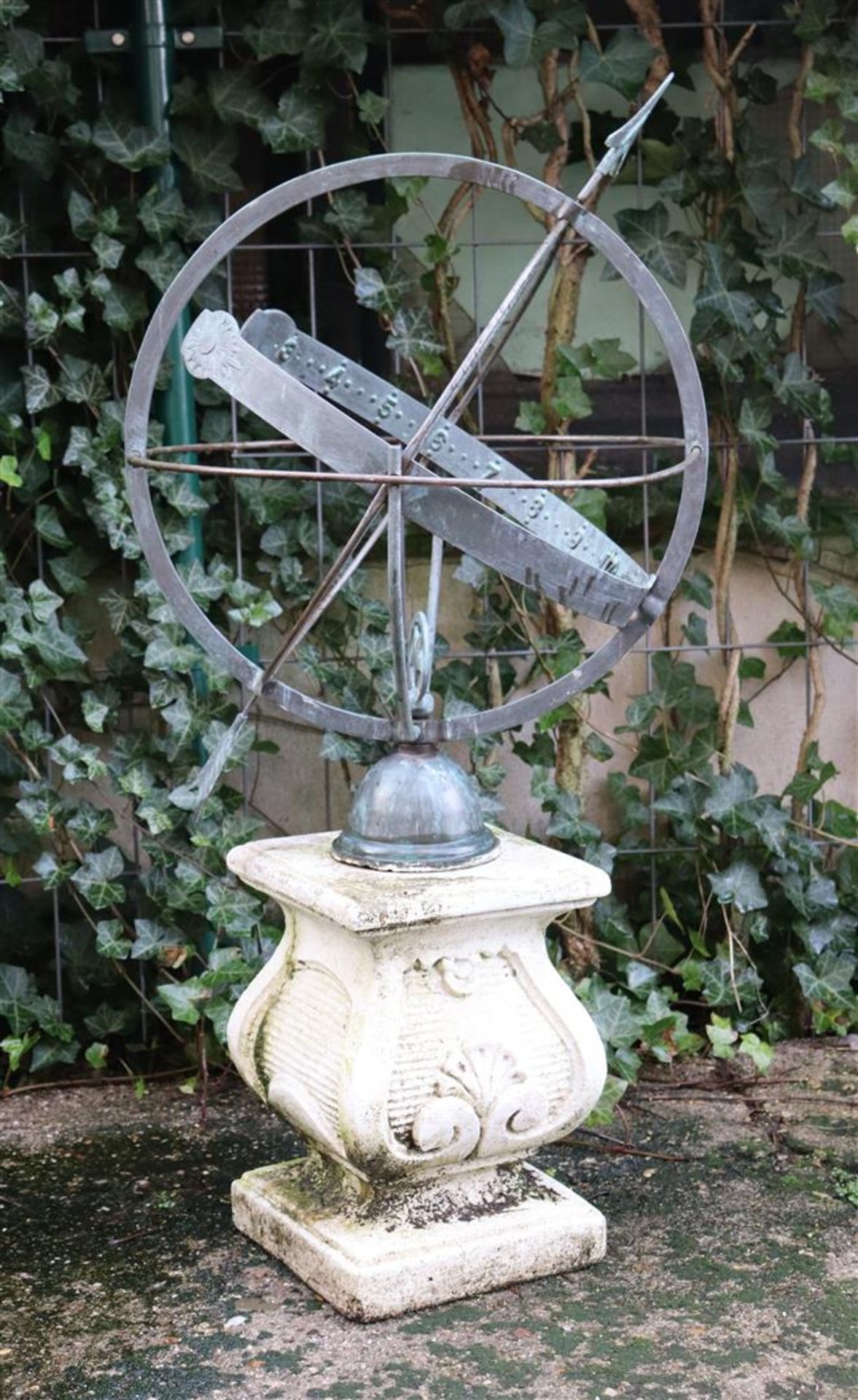 Metal sundial on sandstone plinth