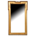 Faceted mirror in gold-colored frame with leaf edge