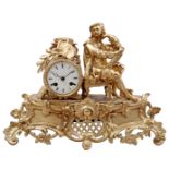 Classic gold-colored mantel clock with painter on top