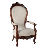Walnut armchair with richly carved crest