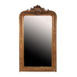 Faceted mirror in a richly decorated gold-colored frame