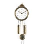 Round brass wall clock with enamelled dial