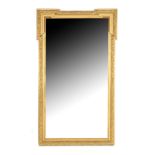 Faceted mirror in richly decorated gold-colored frame