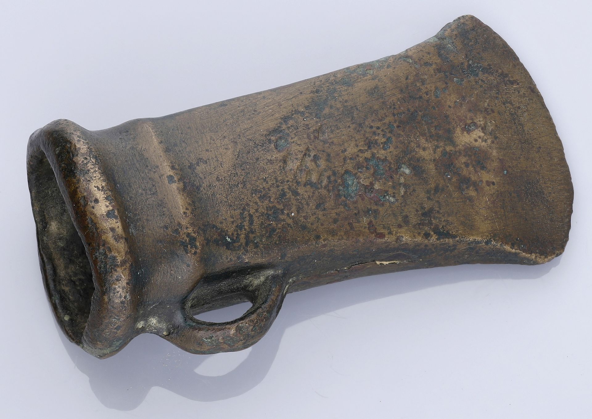 Bronze Age, A socketed and looped axe, c. 1000-800 BC, 8.9cm long by 4.2cm wide by 3.4cm dee...